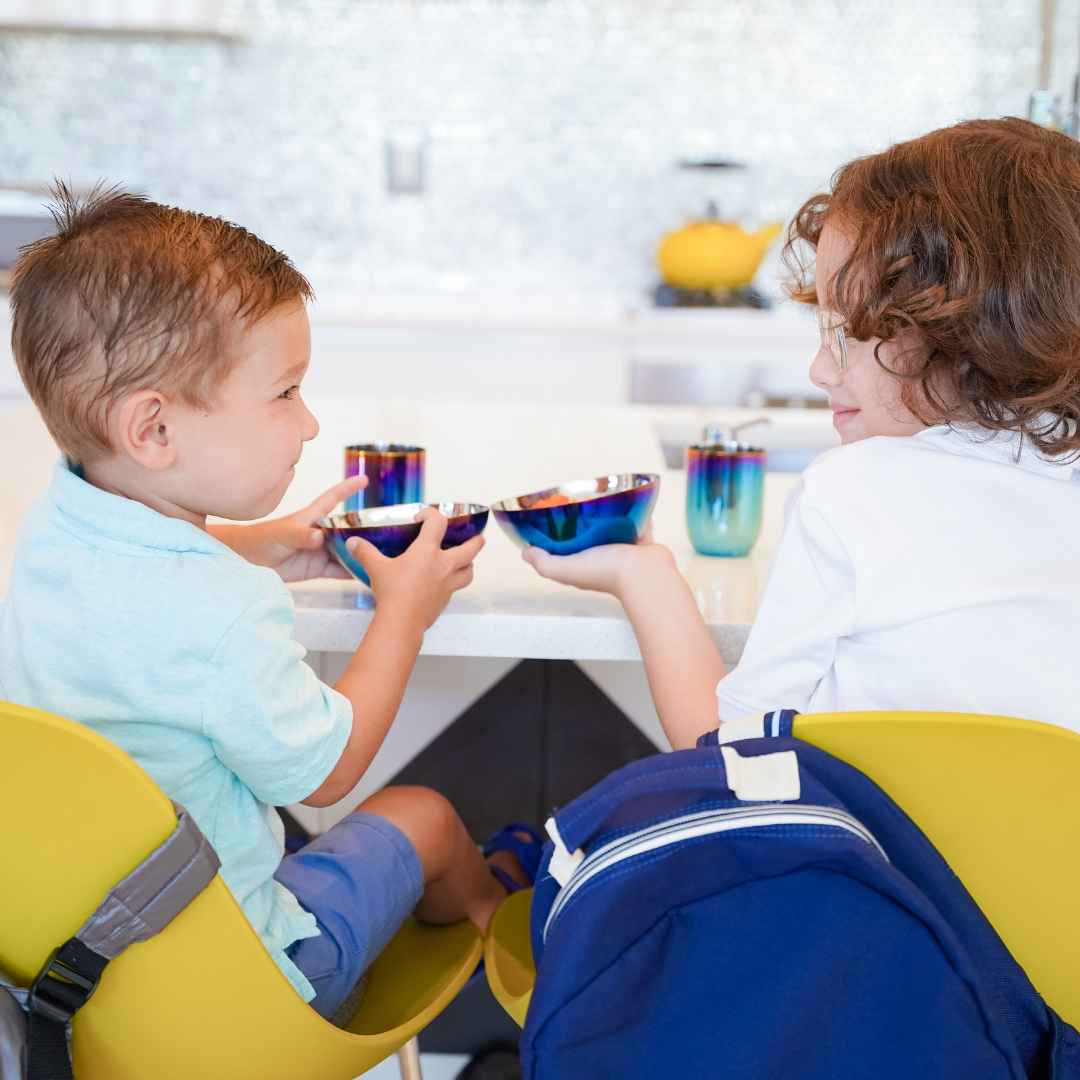 Two kids cheering with ahimsa stainless steel smart snacking bowls