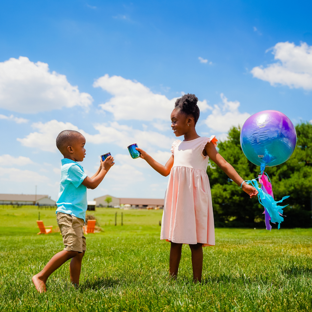 Children cheering outside with Ahimsa iridescent blue stainless steel cups