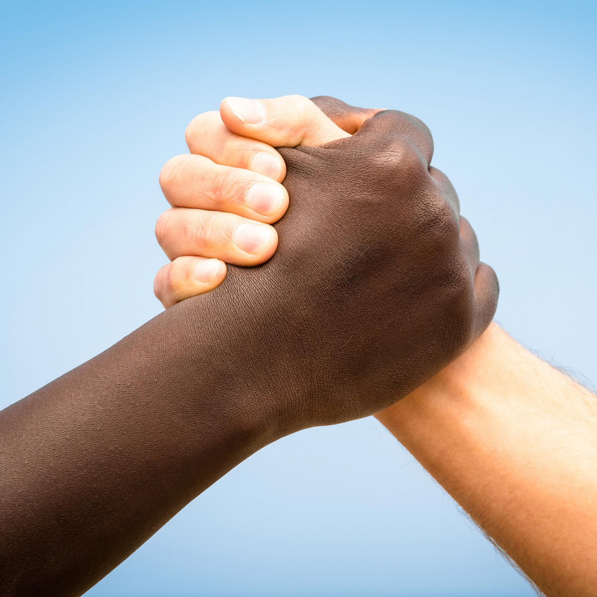 white and black hand clasped