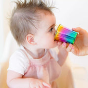 Baby drinking out of stainless steel trainer cup