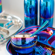 Colorful stainless steel meal or dinnerset with bowl, divided plate, fork and spoon.