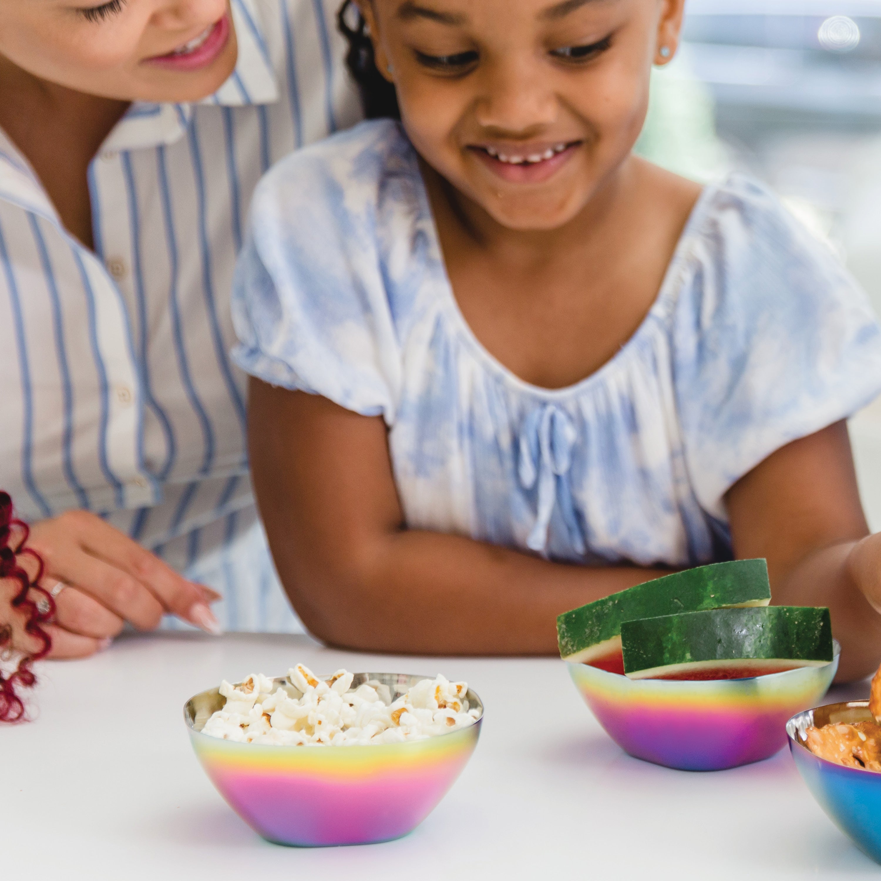 Rainbow stainless steel bowls with fruit and snacks