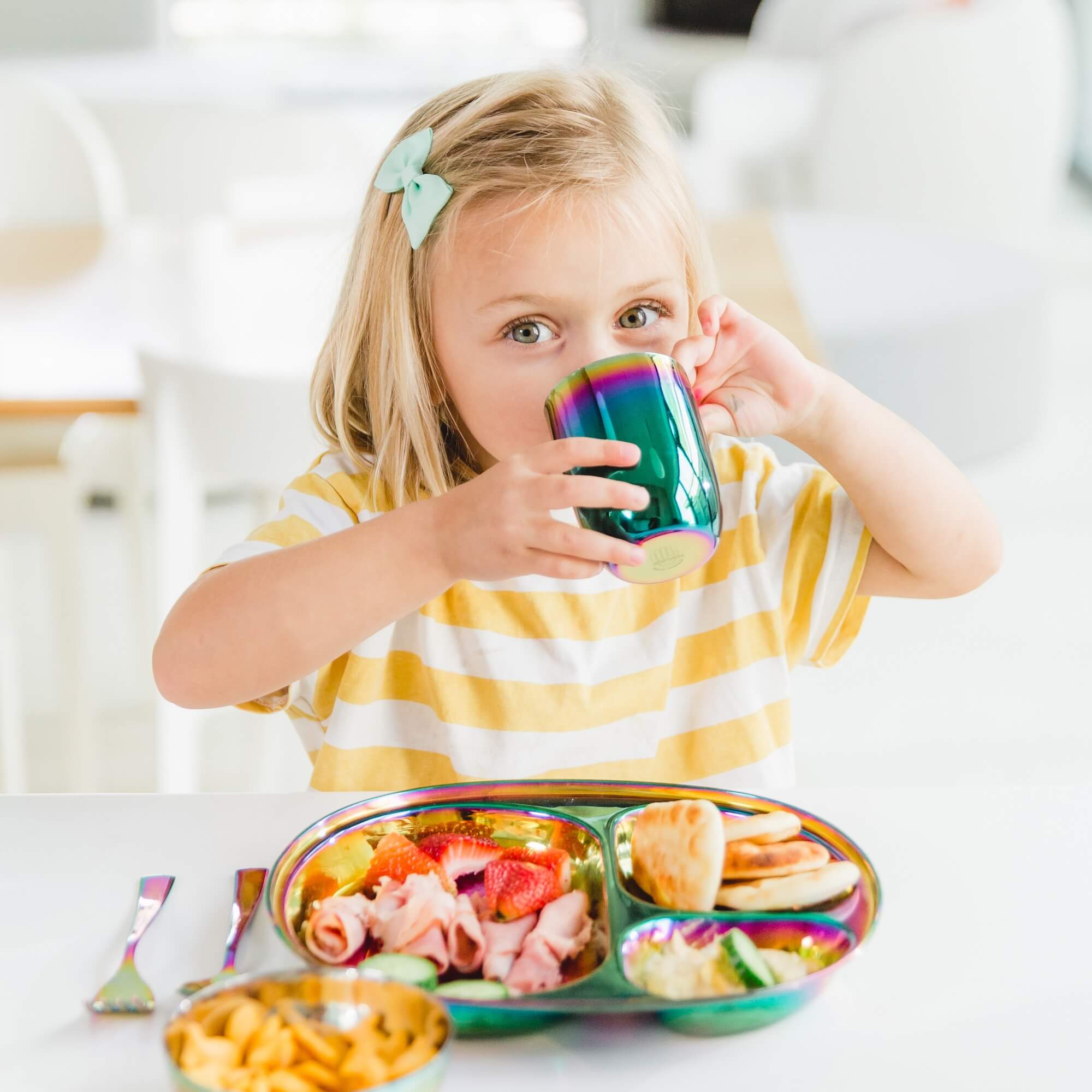 girl eating meal on stainless steel dishes