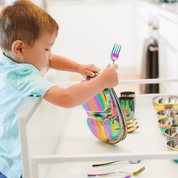 boy with stainless steel dishes