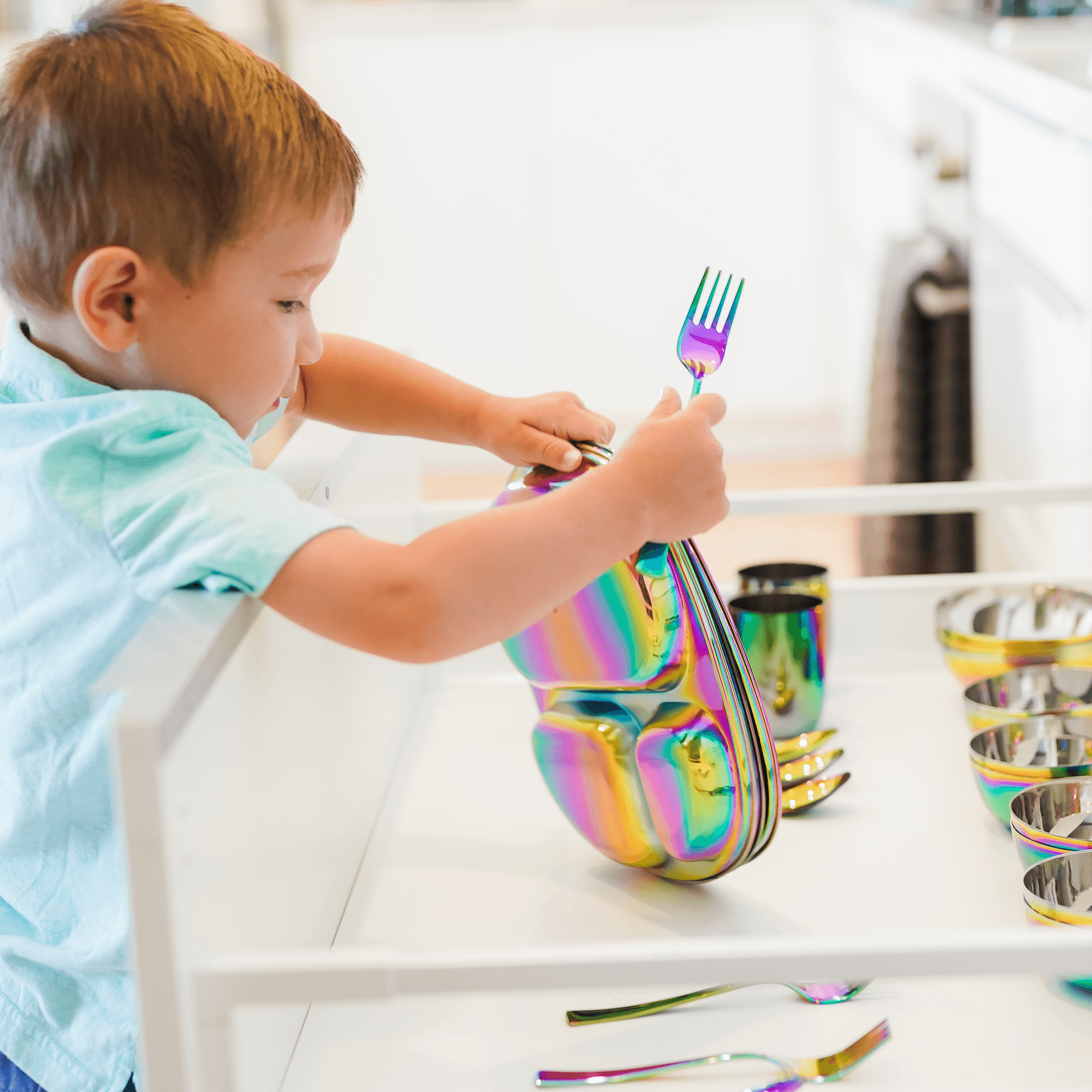 boy with stainless steel dishes
