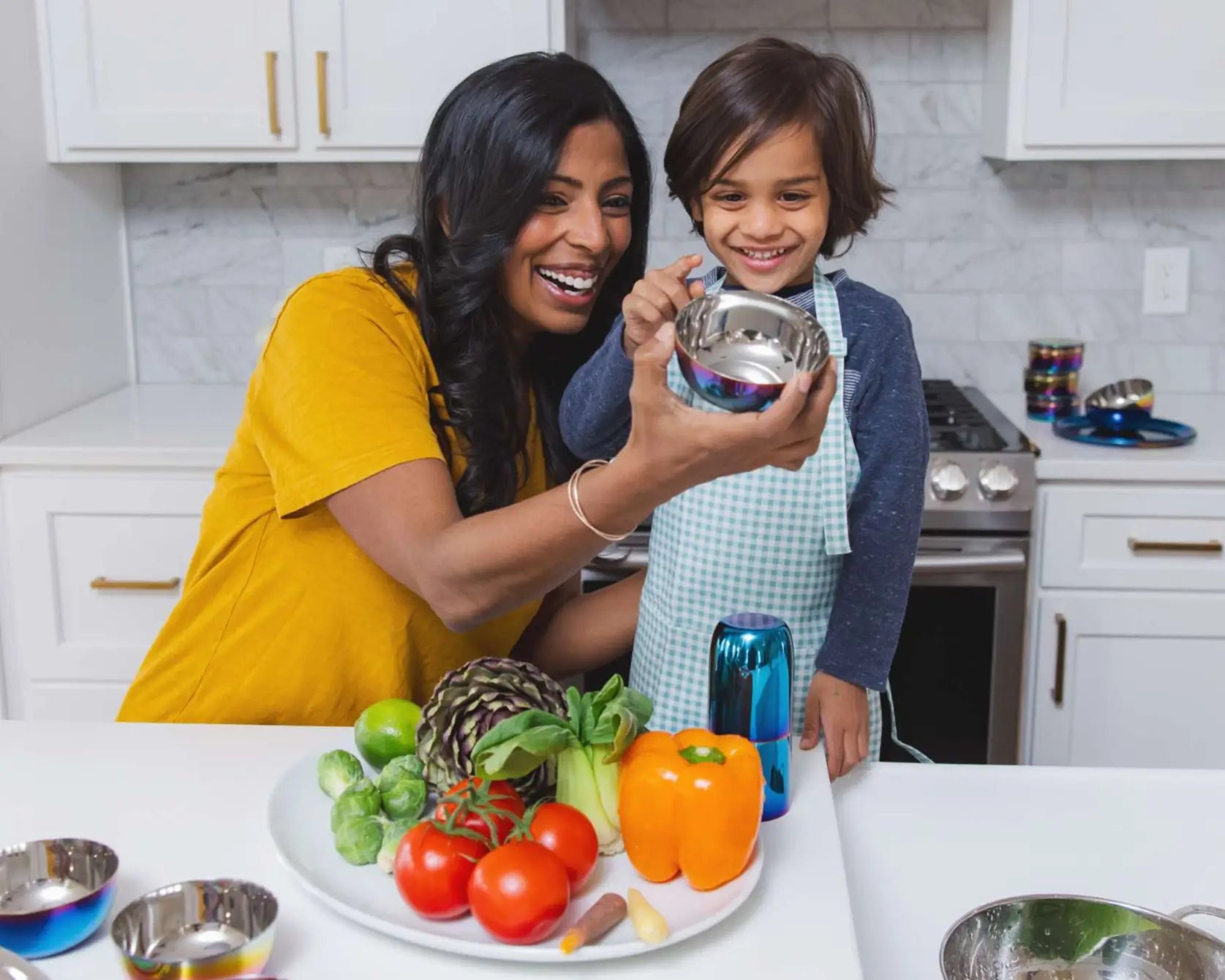 Pediatrician and Mom Dr. M and child enjoying their Ahimsa stainless steel bowl in a kitchen.