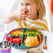 Little girl eating fruit from a Mindful Mealtime Set - with bread, cucumbers, cheese, raspberries, and blueberries