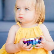 Toddler hold stainless steel bowl with snack