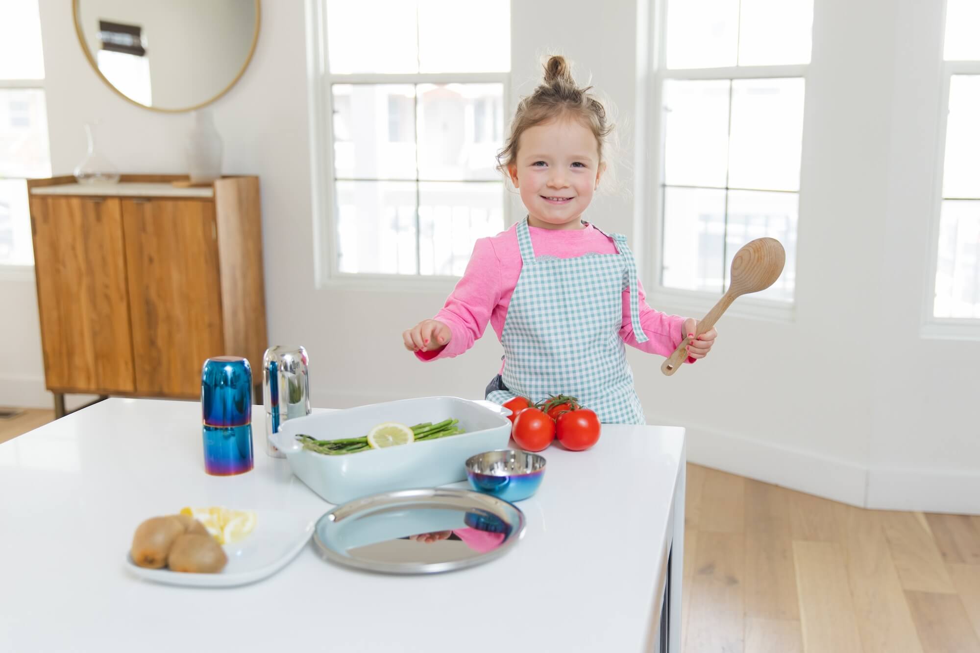 mom and daughter cooking with stainless steel dishes