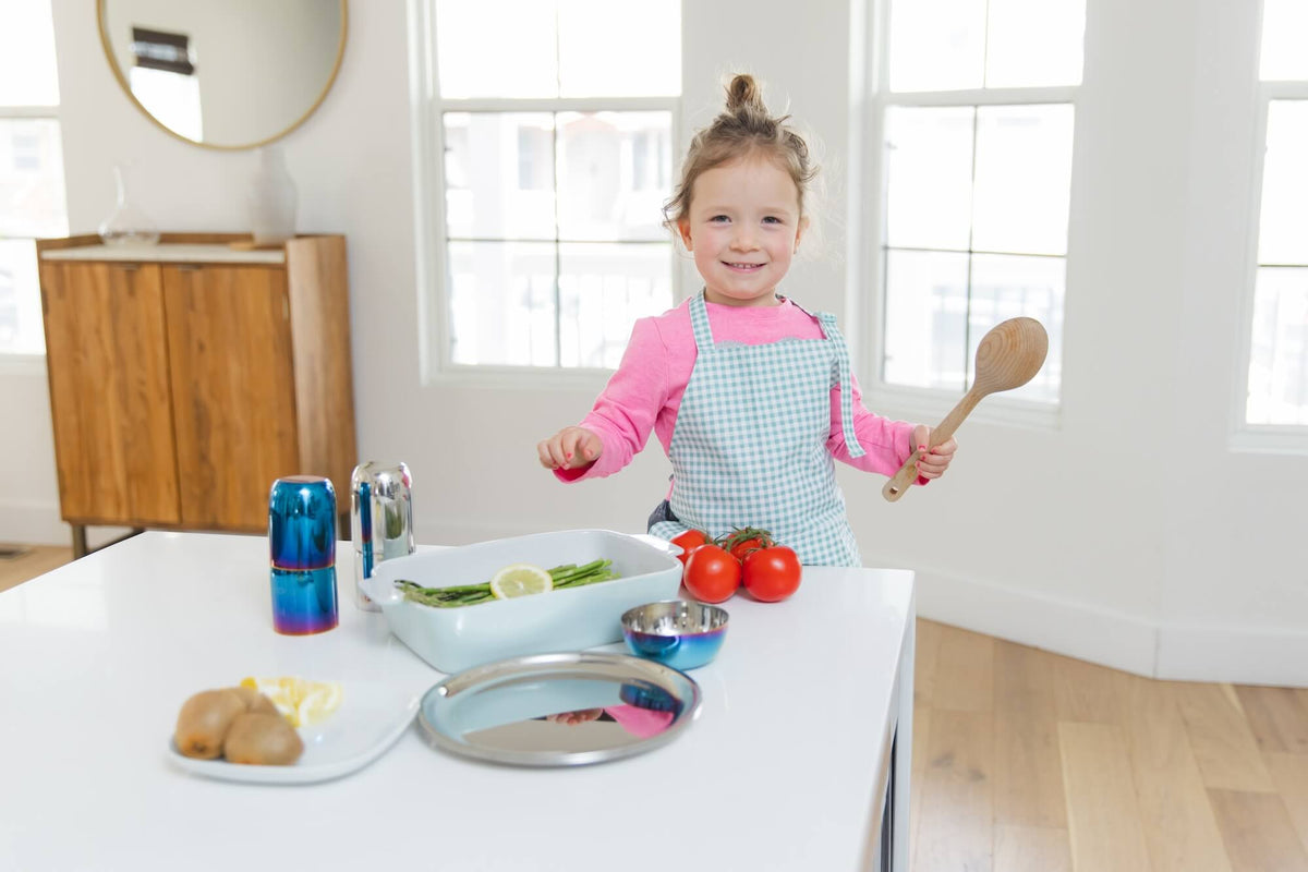 mom and daughter cooking with stainless steel dishes