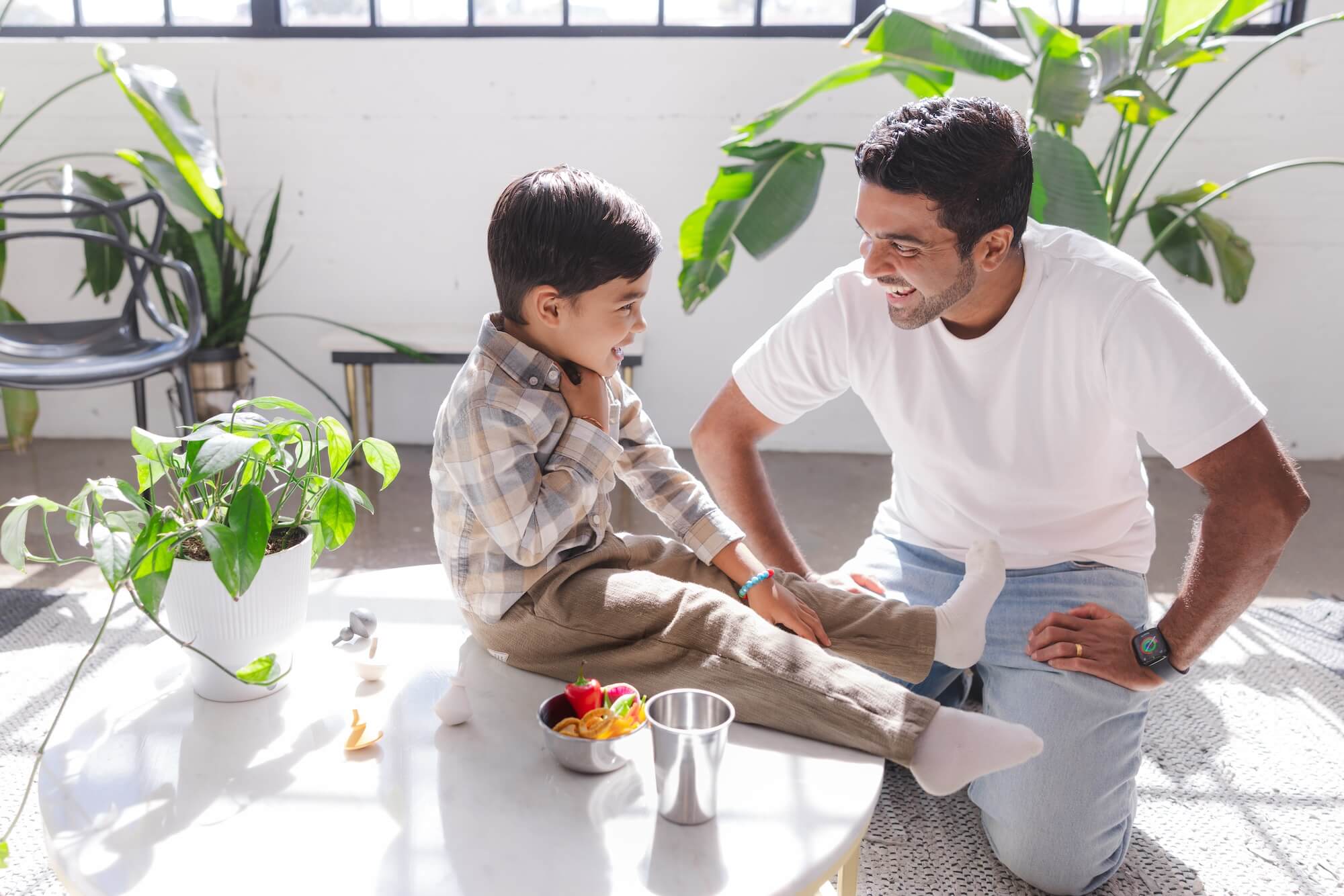 parent and child with food in stainless steel dishes