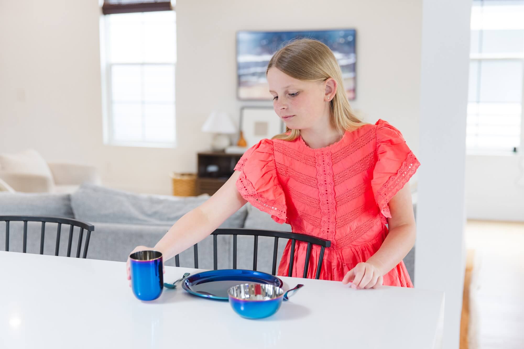child eating with stainless steel dishes