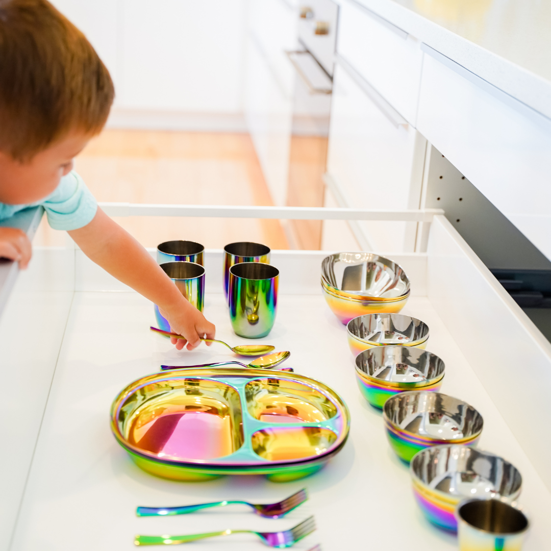 child with stainless steel dishes