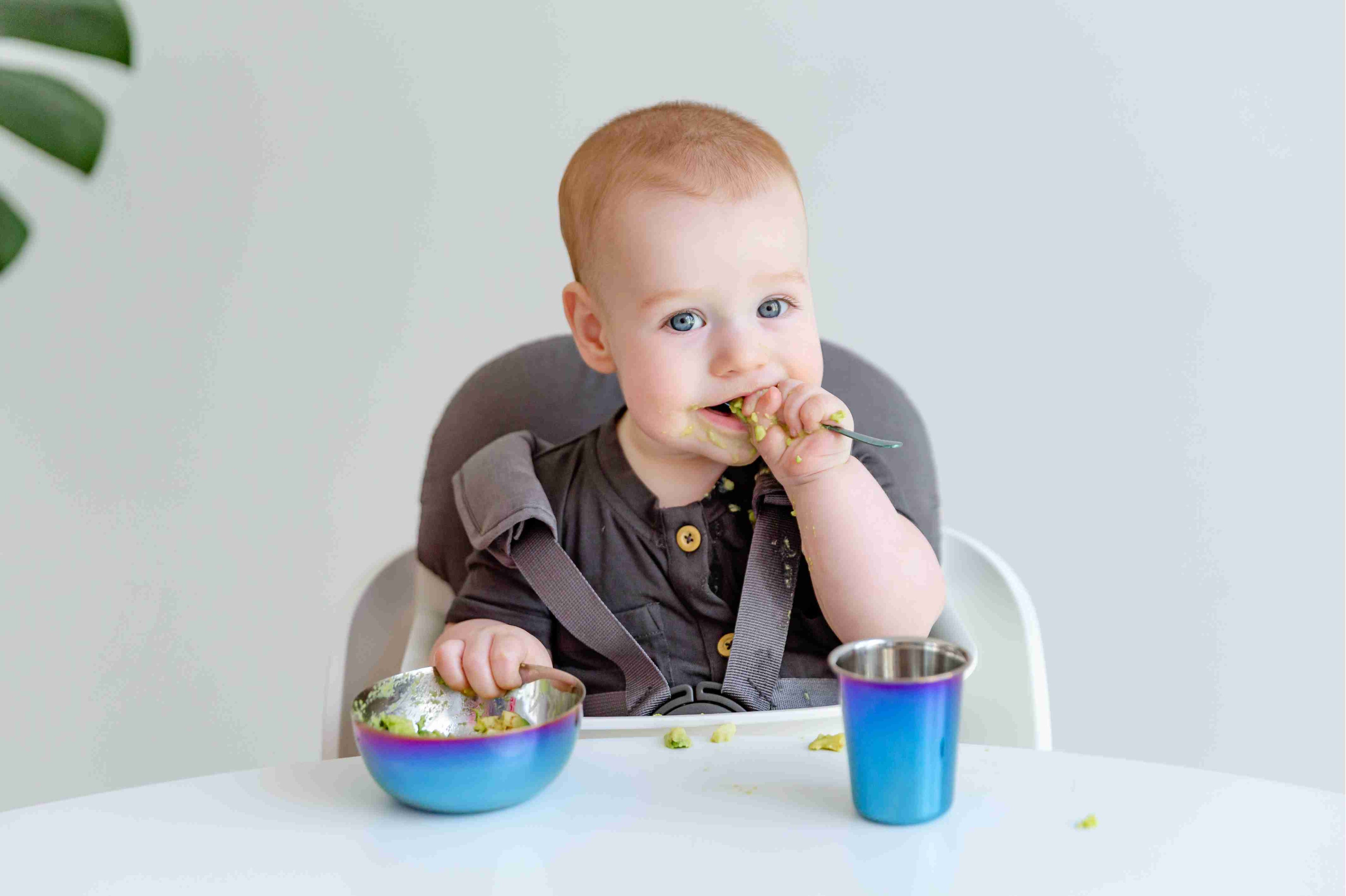 Montessori Kitchen | Child Eating Messily from Spoon