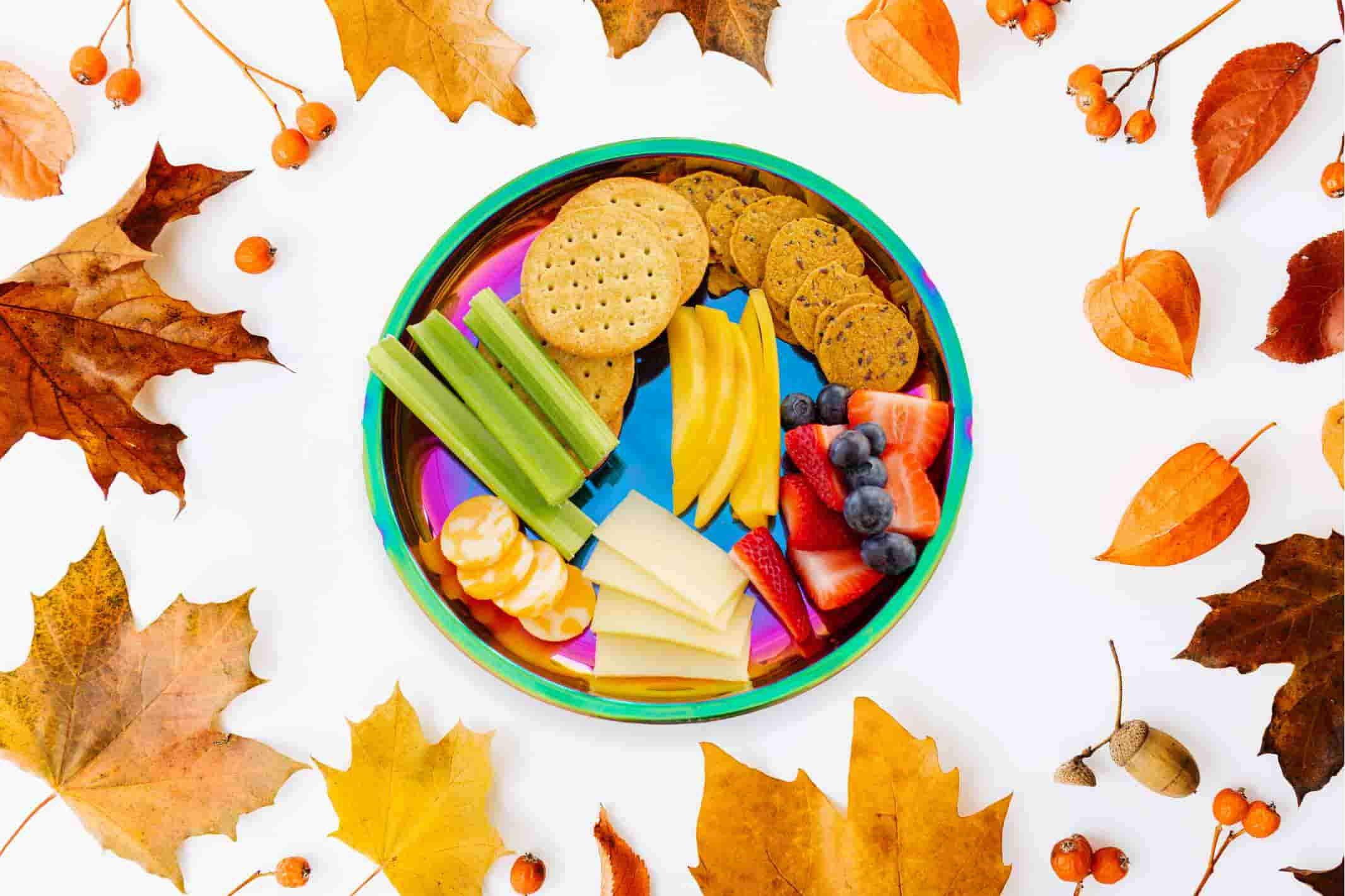 Sustainable Fall Festival Ideas | Snacks in Ahimsa Dishware Surrounded by Leaves