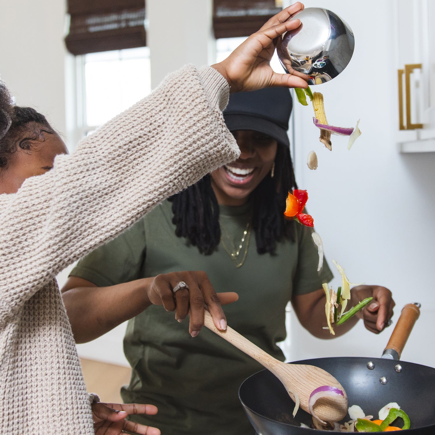 Stainless steel bowls helpful for measuring while cooking, mother and daughter cooking together.