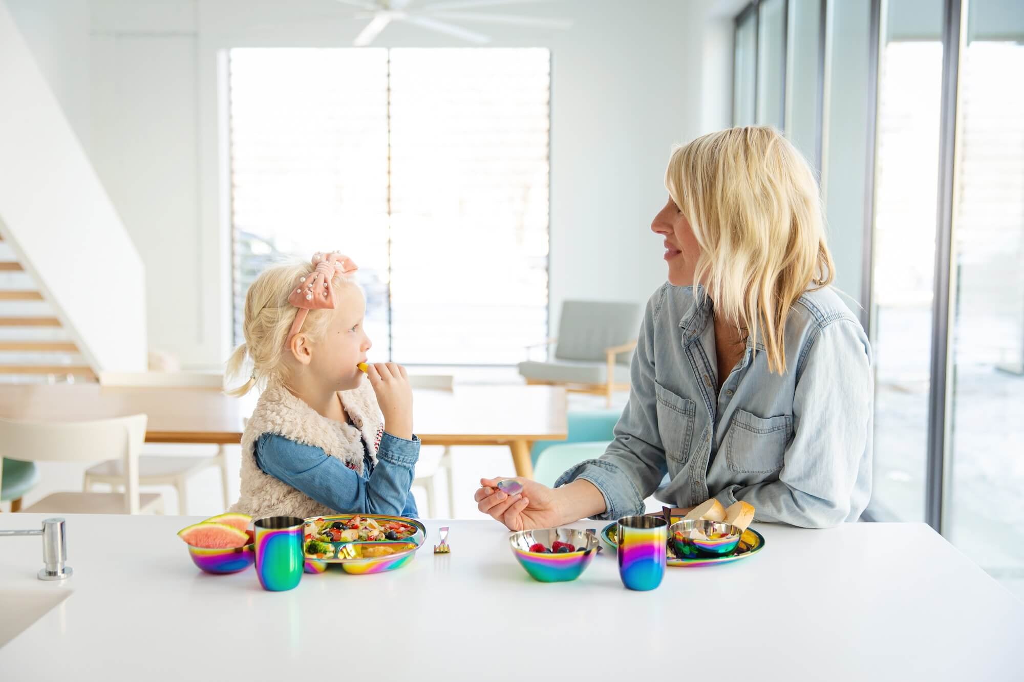 mom with child eating with stainless steel dishes