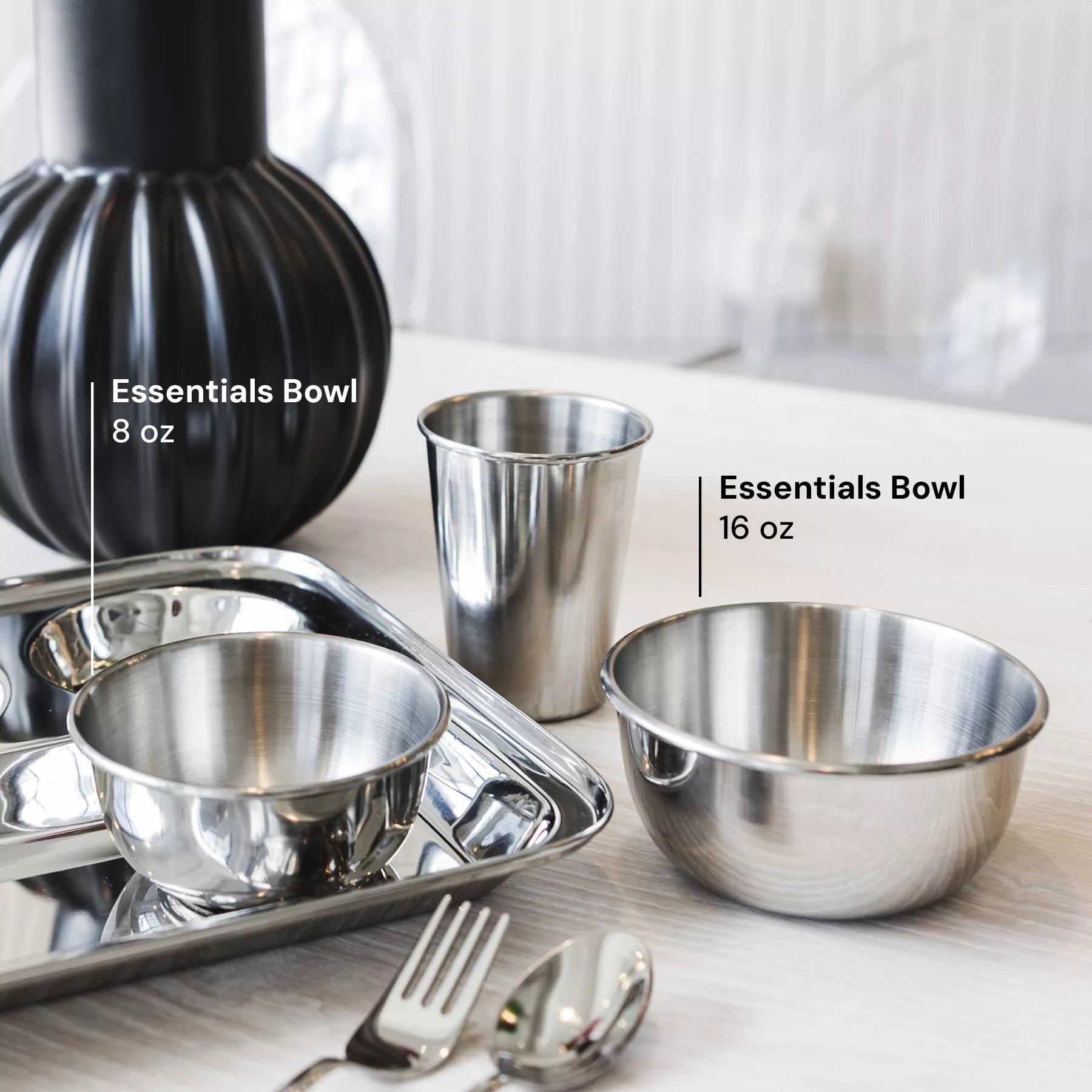 Kids dishes with a modern look that look gorgeous in your kirchen! Ahimsa's dishes are the healthy and beauitful option for dishes for the entire family. The image shows a tray, bowls, a cup and utensils on a table labeled, 8 ounce bowl and 16 ounce bowl labeled for sizing.