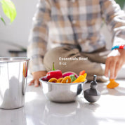 Stainless steel bowl with colorful snacks next to a 10 ounce stainless steel cup. All Ahimsa dishes are Made Safe certified, dishwasher safe, loved by kids, and give peace of mind to parents.