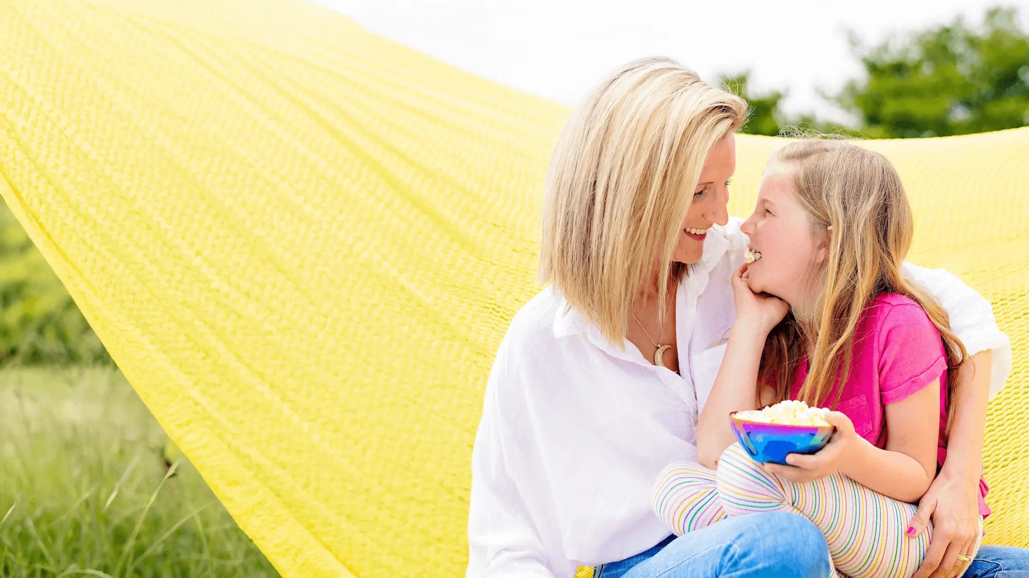 
Mom and daughter looking at each other with a stainless steel kids snack bowl