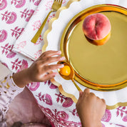 Little hands with Gold Spoon and Gold Purposeful Plate - tomato and peach with beautiful place setting