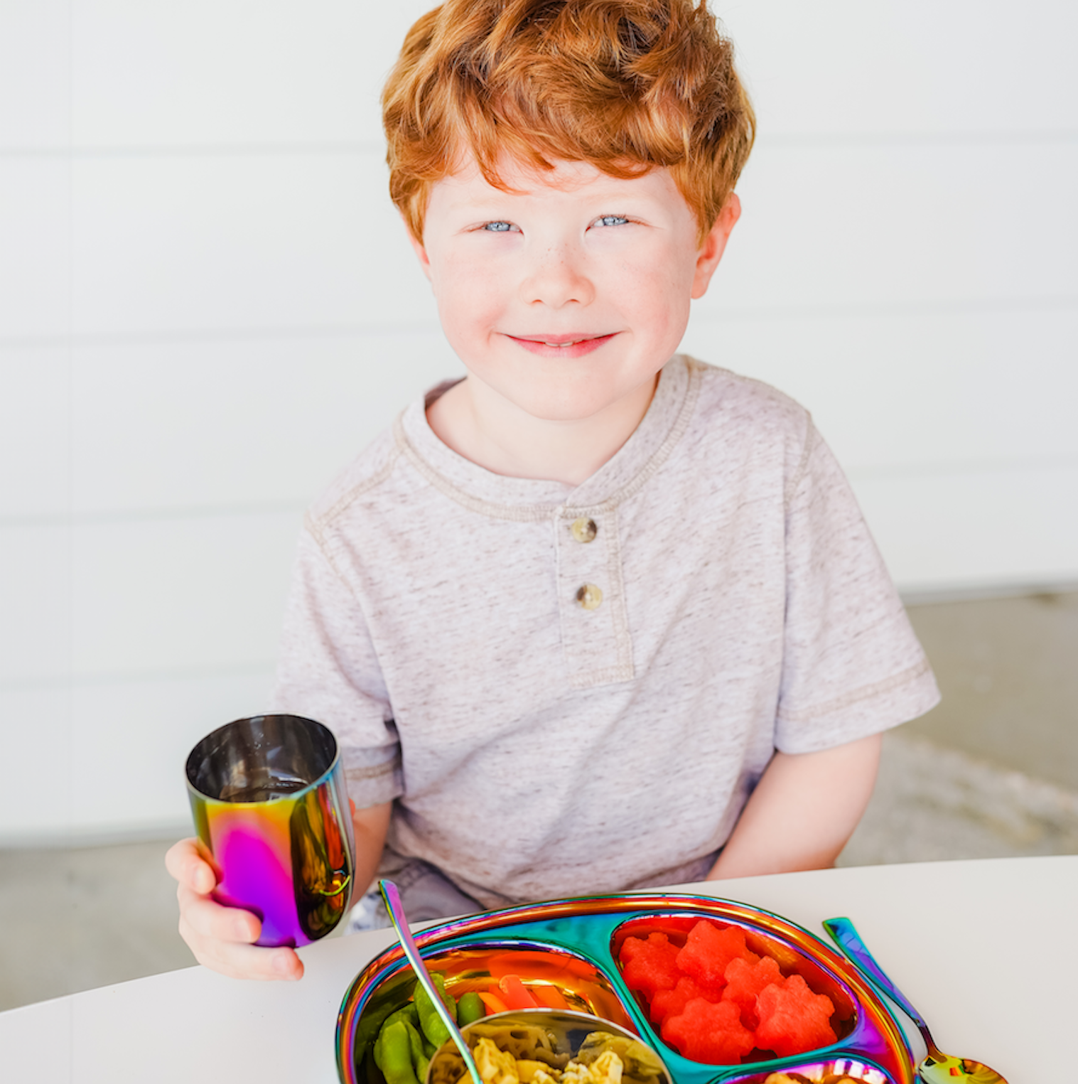 boy with stainless steel dishes and meal