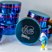 Blue stainless steel food containers with Smurfs logo and a Smurf figurine on a white background