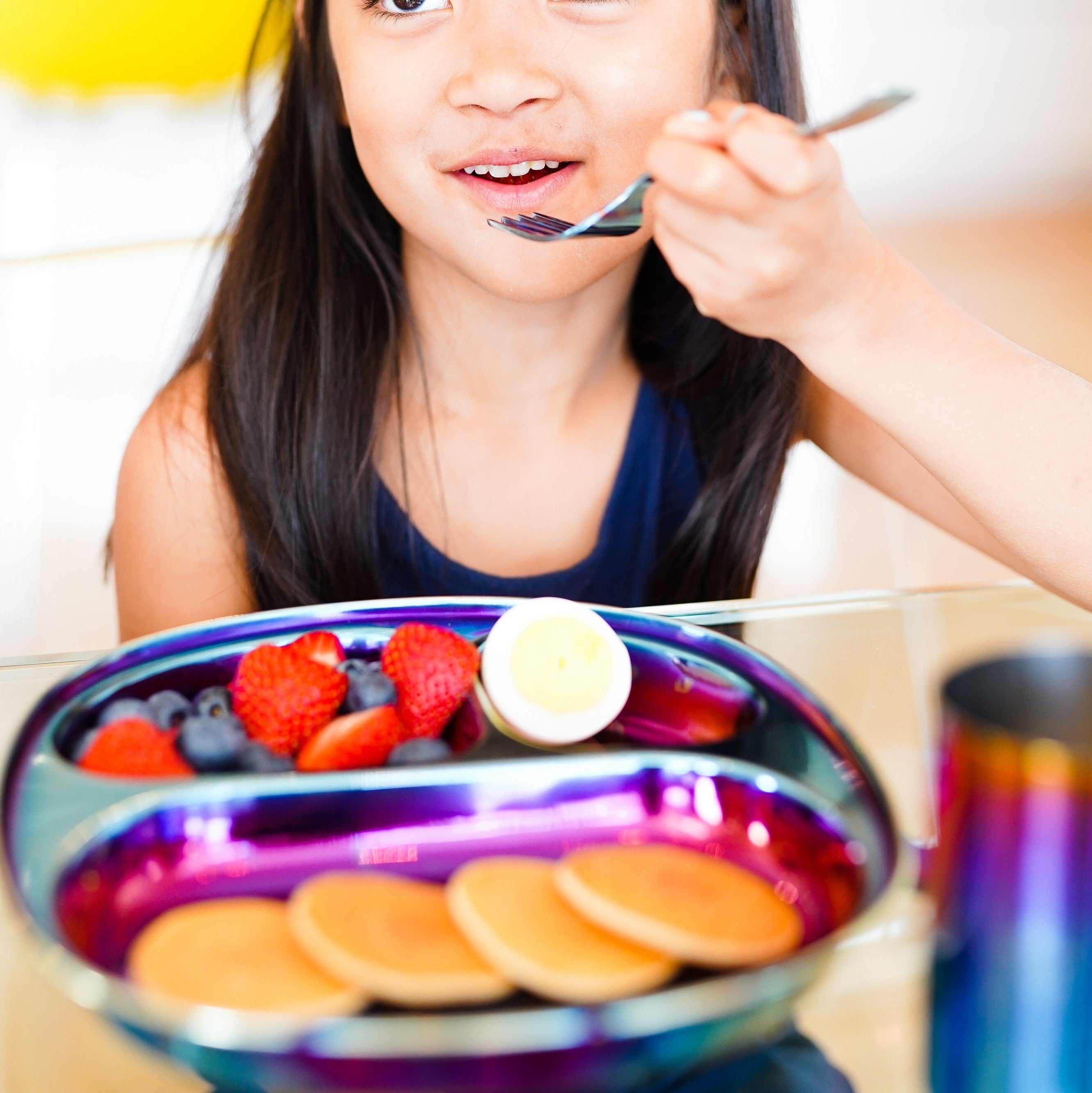 Ahimsa stainless steel dining plates for toddlers, child with fork eating breakfast      