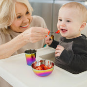 grandmother feeding a baby with ahimsa stainless steel baby spoon, stainless steel baby bowl and stainless steel baby cup