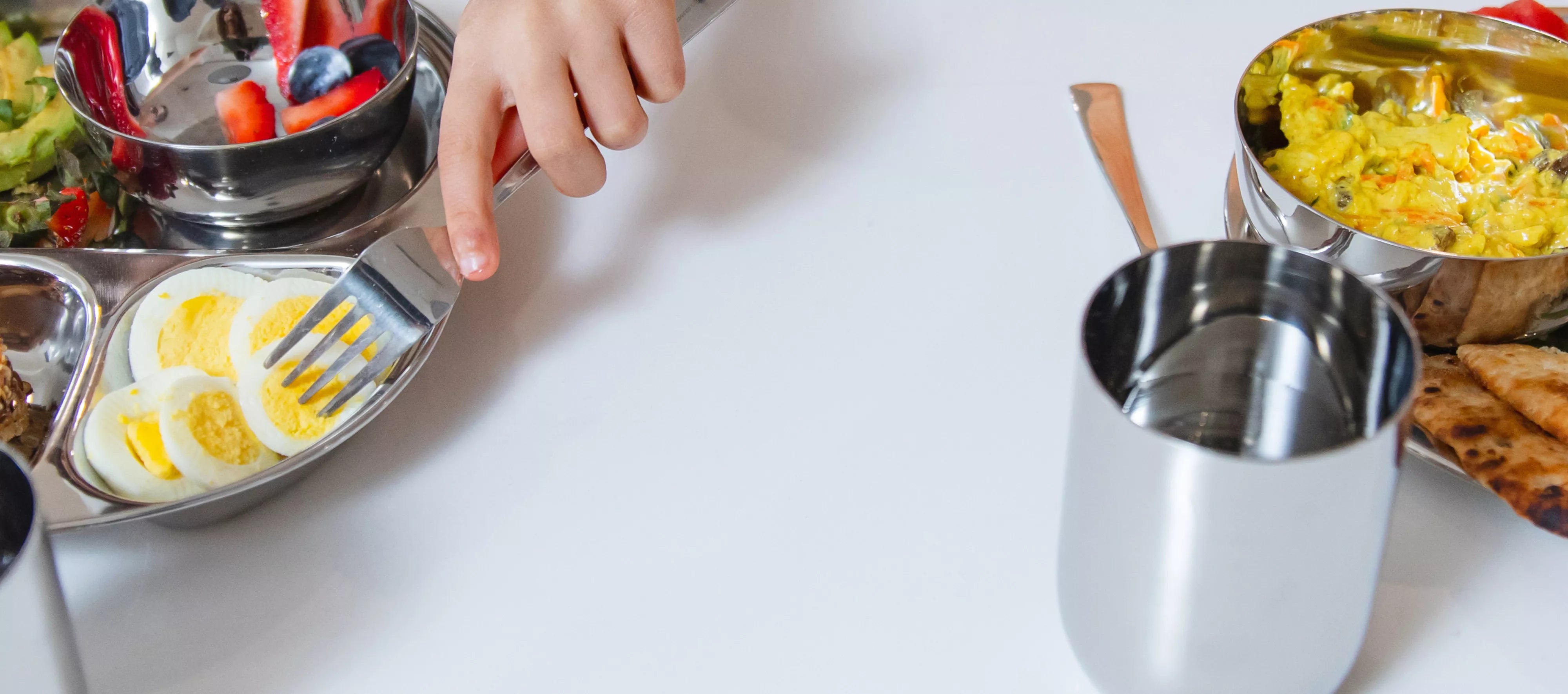 tablescape of classic stainless steel dinnerware for kids