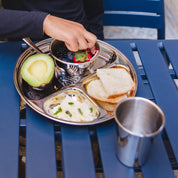 Stainless steel round divided plate with healthy foods and 8 ounce stainless steel bowl with berries nested in the largest compartment. And a stainless steel 10 ounce cup for toddlers and kids. Children love cute plates, bowls, and cups. Parents love quality, durable dishes