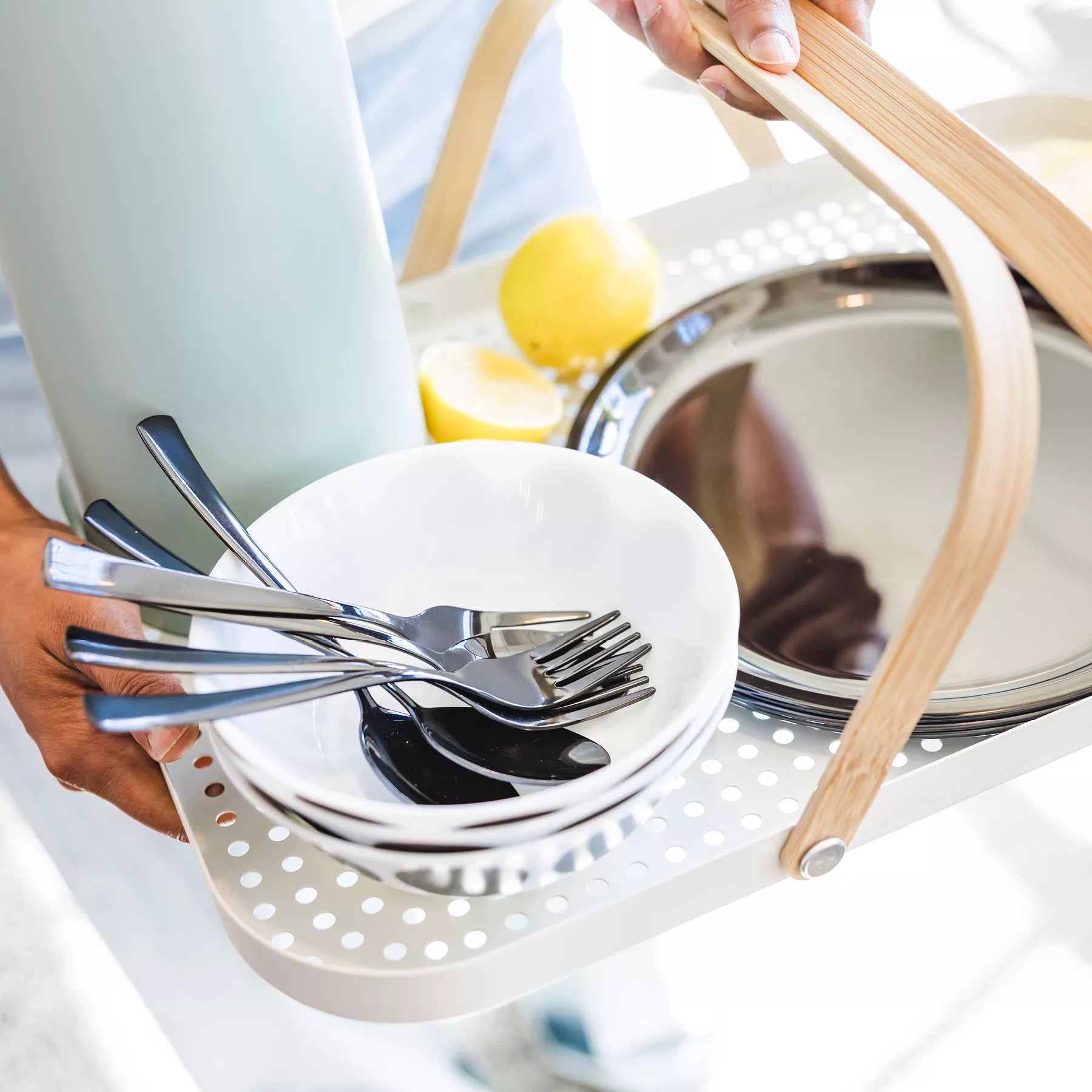 Silverware set in a white bowl with a wooden handle in a tray. Ahimsa's stainless steel utensils are perfect for toddlers, kids, and adults.