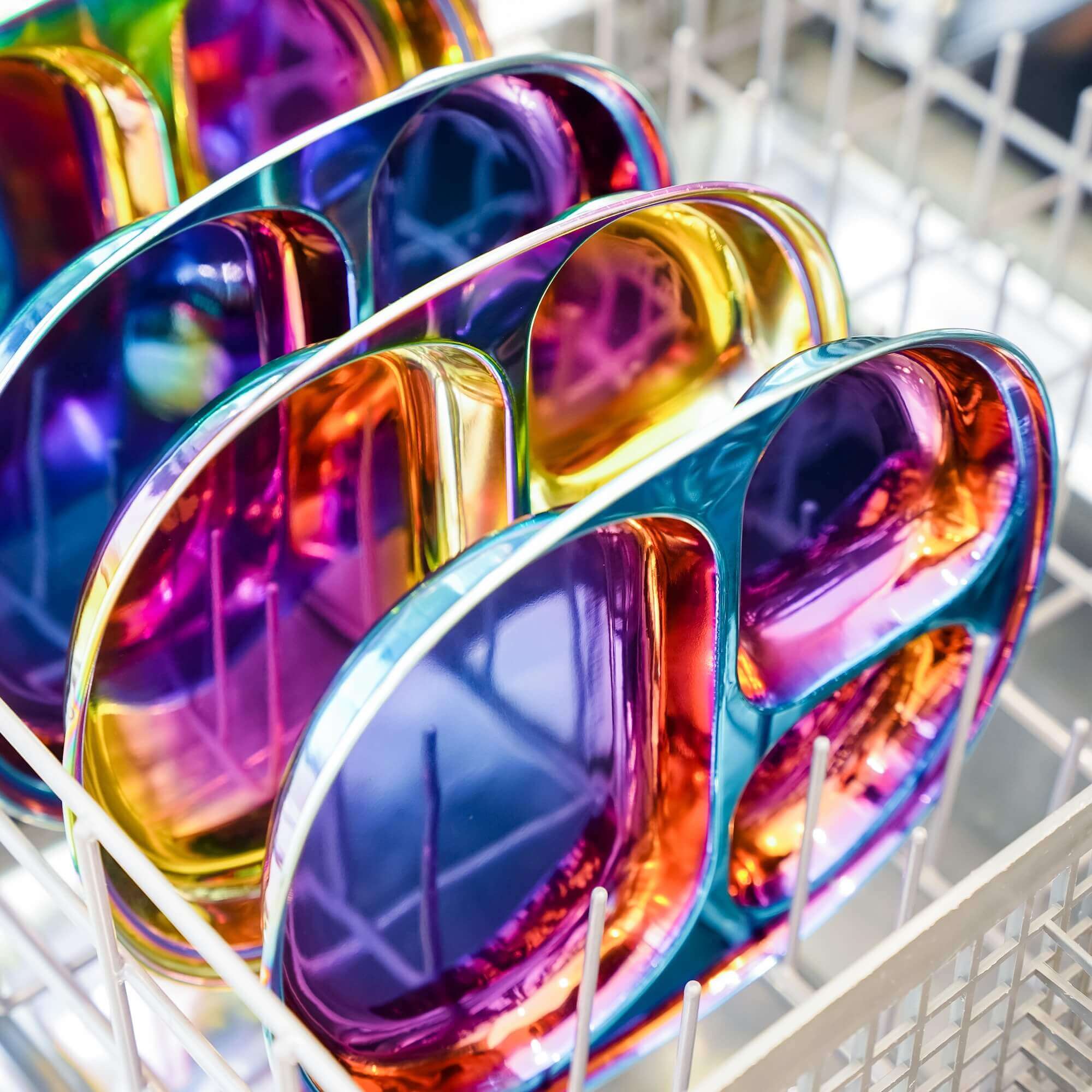 Rainbow stainless steel divided plates in a dishwasher.