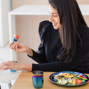 Mom eating from blue stainless steel plate with fork